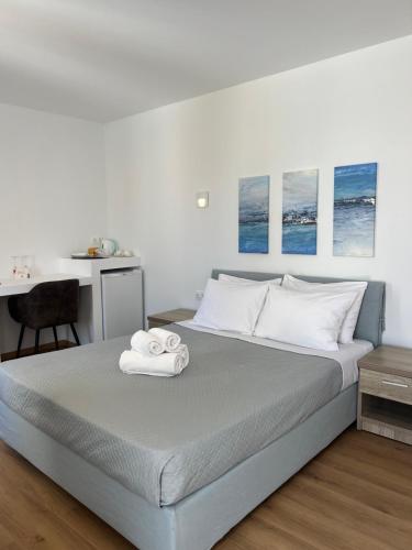a bedroom with a bed with two towels on it at Douskos Guesthouse in Hydra