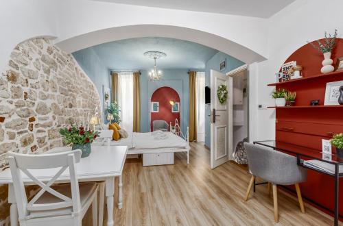 a kitchen and living room with a stone wall at Newly Renovated Romantic Apartment - Primavera Deluxe Rovinj in Rovinj