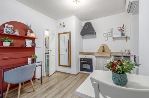 a small kitchen with a white table and chairs at Newly Renovated Romantic Apartment - Primavera Deluxe Rovinj in Rovinj