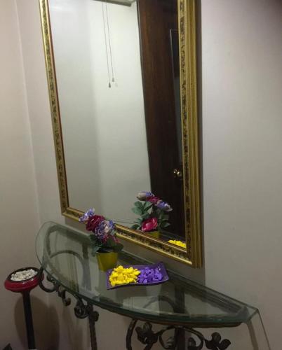 a glass table with flowers on it in front of a mirror at Masal Otel in Kocaeli