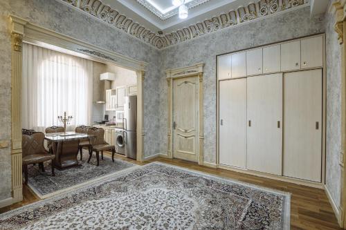 a living room with a table and a dining room at Daniel Hill Hotel in Tashkent