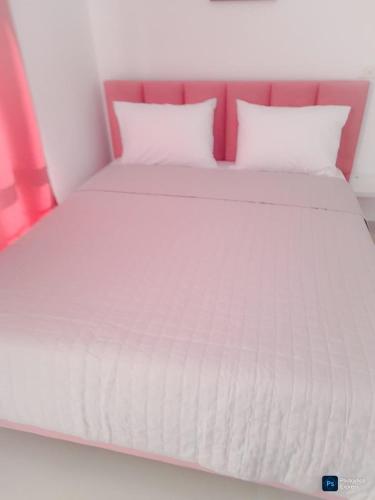 a white bed with white sheets and pillows at Drymades Ruci Rooms in Dhërmi