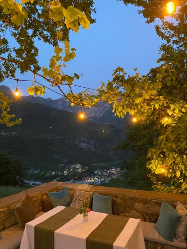 a table and chairs with a view of a valley at Guesthouse Bec Villi in Theth