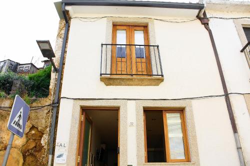 a white building with a window and a balcony at P32 Vila Real in Vila Real
