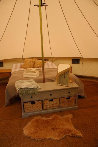 a bedroom with a bed with a mirror on it at Hidden Valley Dorset in Powerstock