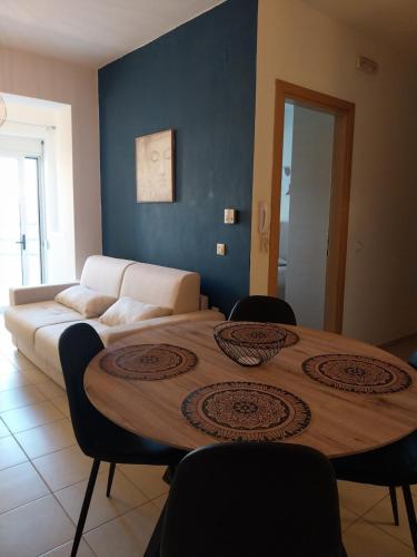 a table in a room with a couch and a table at Ifigeneia Infinity Suites in Néa Alikarnassós
