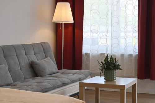a living room with a couch and a table at Hotel Garni Pension Gambrinus in Passau
