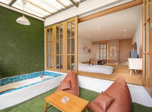 a bedroom with a tub and a bed in a room at Japanese House 3BR Home Near Ekkamai BTS in Bangkok