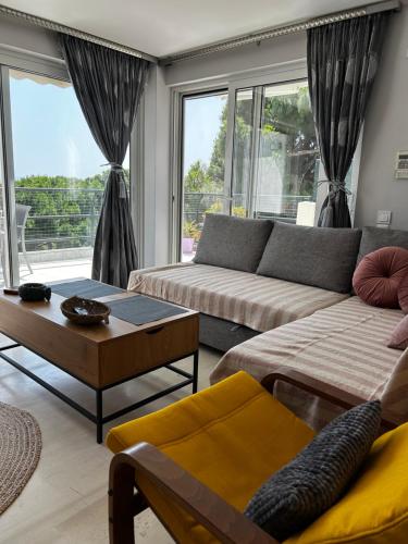 a living room with a couch and a table at HalCyon-On the blue in Nea Makri