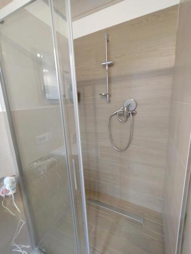 a shower with a glass door in a bathroom at Luna Fortunata - Fano City Loft in Fano