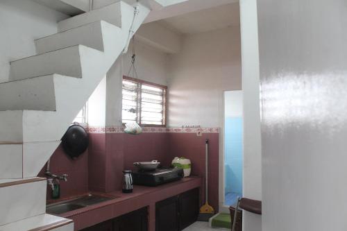 a kitchen with a sink and a counter top at Rumah Mama Homestay Syariah in Bukittinggi