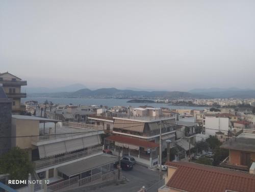 a city with buildings and a body of water at John's House in Chalkida