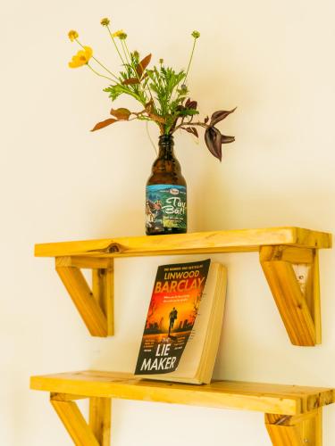 a wooden shelf with a book and a vase at Sapa Riverside Homestay in Sa Pa