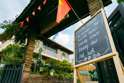 a sign in front of a building with a restaurant at Sapa Riverside Homestay in Sa Pa