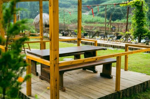 a wooden bench sitting on a wooden deck at Sapa Riverside Homestay in Sa Pa