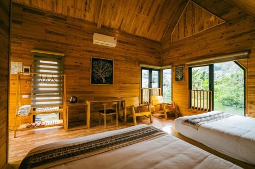 a bedroom with two beds and a desk in a room at Sapa Riverside Homestay in Sa Pa
