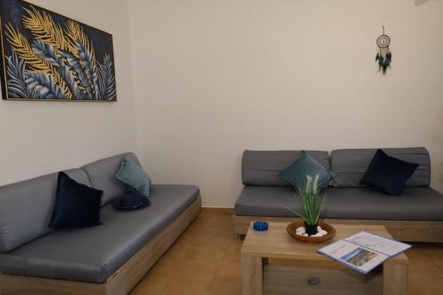 a living room with a couch and a table at Royal Touch Suite in Loutra