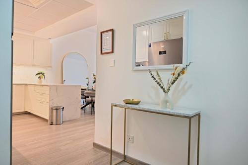 a kitchen and living room with a counter and a table at Air Homes - Stylish Urban Living in a Modern 1BR in Dubai