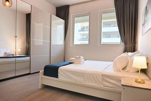 a bedroom with a bed and a mirror at Air Homes - Stylish Urban Living in a Modern 1BR in Dubai