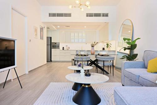 a living room with a couch and a table at Air Homes - Stylish Urban Living in a Modern 1BR in Dubai