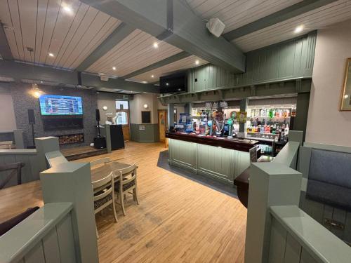 a restaurant with a table and a bar at Rathlin Apartment 1 bedroom in Ballycastle