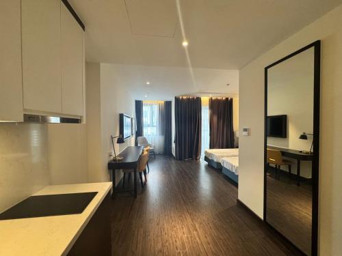 a room with a bed and a desk in a room at Lavender House- The Sapphire Resident 2 in Ha Long