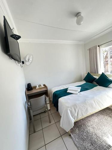 Ένα ή περισσότερα κρεβάτια σε δωμάτιο στο Creekside Guest House Middelburg