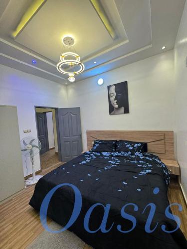 una camera da letto con un letto grande con un cartello sopra di Oasis a Cotonou