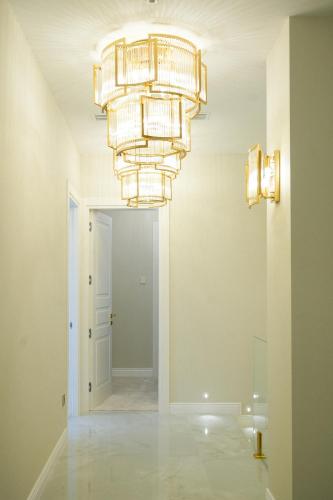 a large chandelier in a room with a hallway at Azimuth Hotel By Building Stefan Resort I Nord in Mamaia Sat/Năvodari