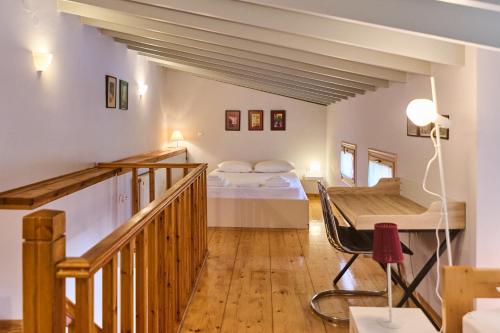 a bedroom with two beds and a wooden staircase at D BERNARDAKI Garden House in Mytilene