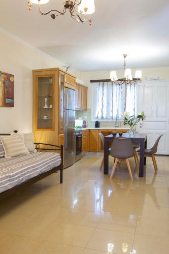 a living room with a bed and a table and a kitchen at Pantazis Studios in Agios Nikitas in Agios Nikitas
