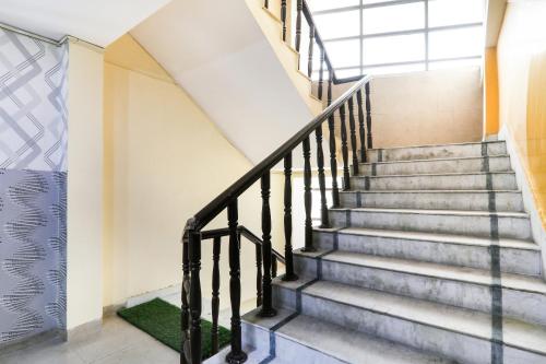 a staircase in a building with a window at Hotel O Priyal in Chās