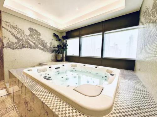 a large bath tub in a bathroom with a large window at WonderfulStay at Paramount Residences - Highest Infinity Pool - Burj Khalifa View - Brand New Luxury Apartments in Dubai