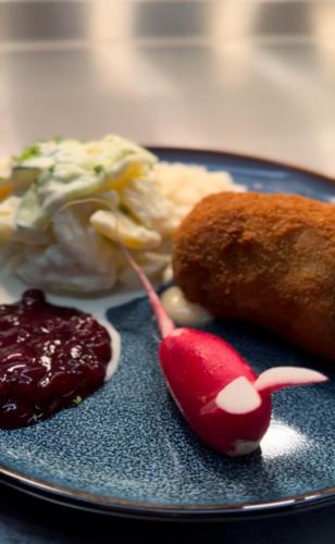 a blue plate with food on a table at Bata Club Haus in Möhlin