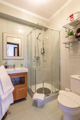 a bathroom with a shower and a toilet and a sink at SunHouse Room in Albufeira