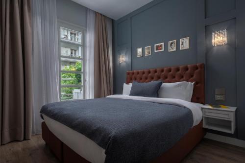 a bedroom with a large bed and a window at No 39 Svolou Suites in Thessaloniki