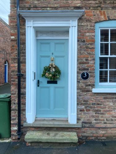 a blue door with a wreath on it at The Old Penny Bank in Barrow upon Humber