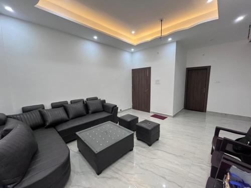 a living room with a couch and a coffee table at Hridayam Kashi Homestay in Varanasi