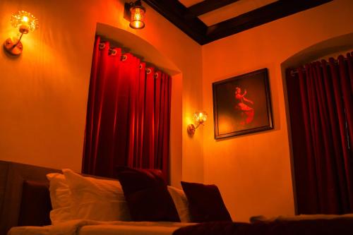 a bedroom with red drapes and a bed at Chithrapuri Heritage Hotels Pvt Ltd in Alattūr