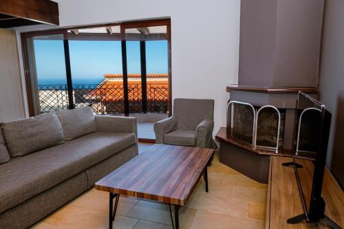 a living room with a couch and a fireplace at OntasView Rodia in Rodia