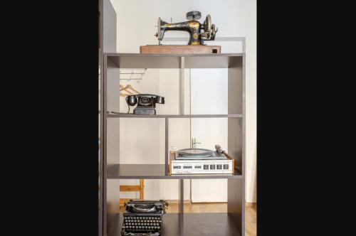 a shelf with a radio and a sewing machine at VakeInVake in Tbilisi City