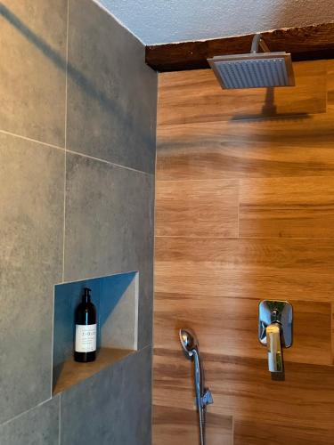a bottle of wine sitting on a shelf in a bathroom at Apartman Thermea in Krapinske Toplice