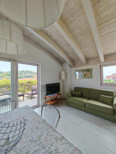 a living room with a couch and a table at Nuova Opera Rooms in Verona