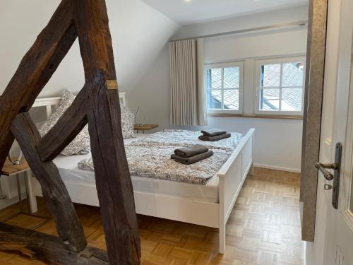 a bedroom with a bed with two towels on it at Ferienhaus Schröder OM 3 Altstadt in Monschau