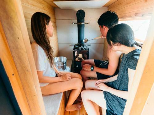 a group of three people sitting inside of a stove at UNPLAN Residence suite in Chikuni