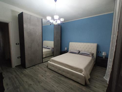 a bedroom with a bed and a large mirror at Valentina's garden house in Triei