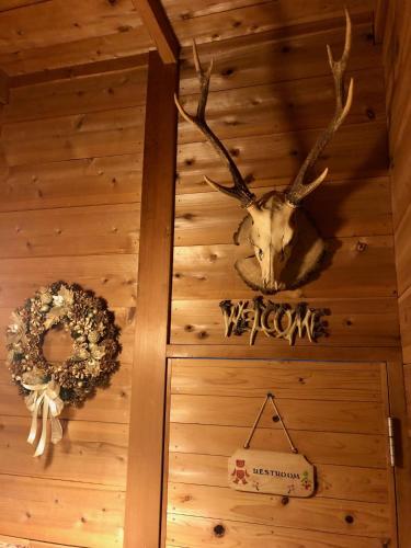 a deer head on the wall of a room at ドッグランドサムデイ in Minamitsuru