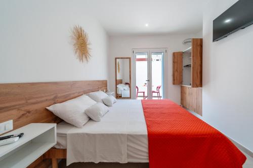 a bedroom with a large bed with a red and white blanket at Costamar Vacanze in Lido Marini