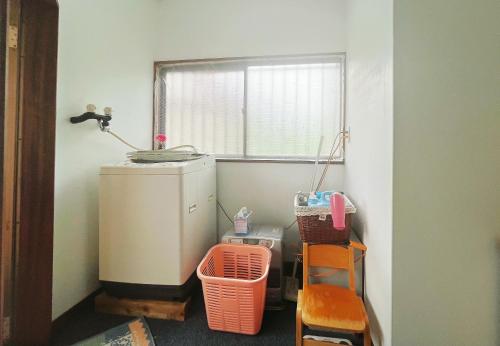 a small room with a window and a water heater at 二番館 温泉街まで徒歩15分の落ち着く一軒家 in Kusatsu