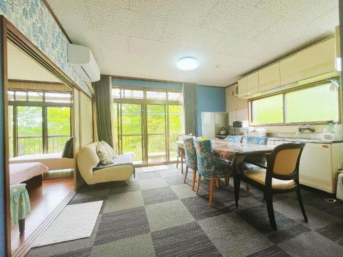 a kitchen and dining room with a table and chairs at 二番館 温泉街まで徒歩15分の落ち着く一軒家 in Kusatsu